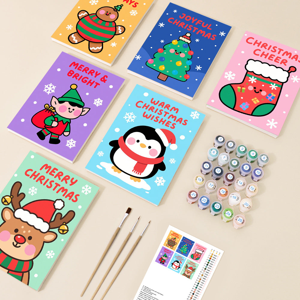 A collection of six cute, cartoon Christmas themed paint by number canvases featuring characters like a reindeer, penguin, and elf, accompanied by paints and brushes.