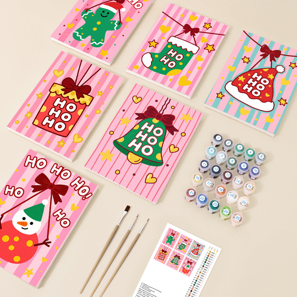 A set of small, vibrant paint-by-number canvases featuring cheerful cartoon Christmas designs like a gingerbread man, stocking, Santa hat, bell, present, and snowman, alongside paints and brushes, all on a light background.