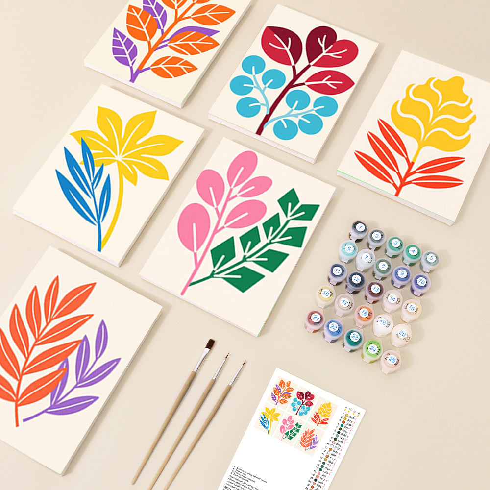 A collection of paint by number canvases featuring various stylized botanical leaf designs in a modern, vibrant colour palette, alongside paints and brushes.