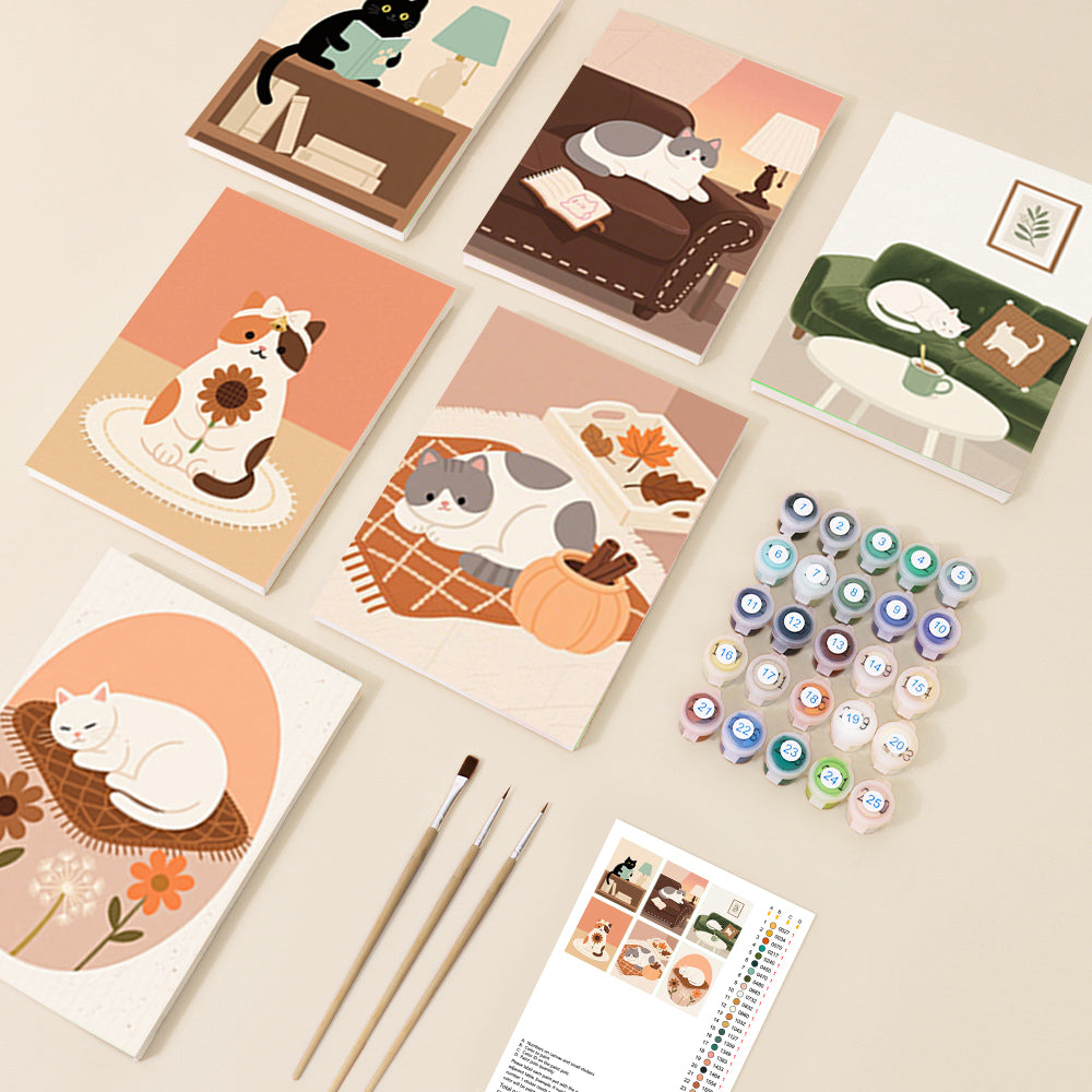 Multiple charming paint by number canvases depicting cute, stylized cats in cozy domestic and seasonal settings, rendered in a warm, illustrative art style.