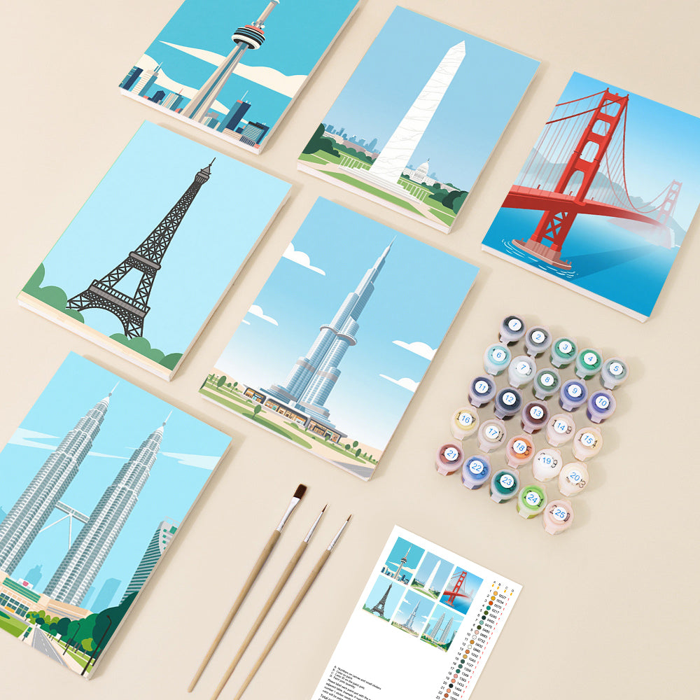 A collection of six minimalist paint by number canvases featuring iconic global landmarks, surrounded by numbered paint pots and brushes, presented in a clean and bright setting.