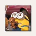 A bright yellow Minion character wearing blue overalls and large goggles, gently holding a small brown teddy bear, depicted in a cheerful animated style.