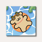 A cute, cartoon-style bear wearing pineapple sunglasses floats on an orange swim ring in blue water, depicted with a playful and summery mood.