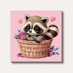 A cartoon style image of an adorable raccoon with large blue eyes sitting inside a brown woven basket filled with pink roses and blue leaves, set against a bright pink background with two floating pink hearts.