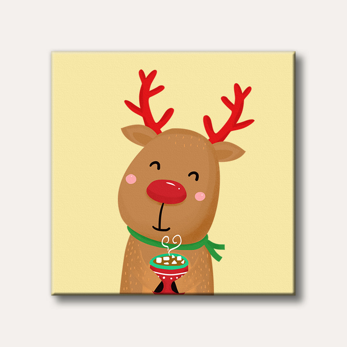A cheerful cartoon reindeer with red antlers and a bright red nose smiles while holding a steaming mug of hot chocolate with marshmallows against a soft yellow background.